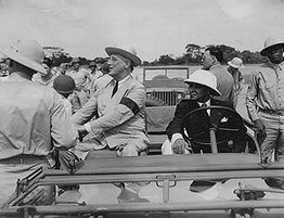 Franklin Roosevelt in car and people standing around it